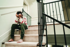 Sad teen boy on steps